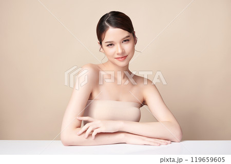 Beautiful young asian woman with clean fresh skin on beige background, Face care, Facial treatment, Cosmetology, beauty and spa, Asian women portrait. 119659605