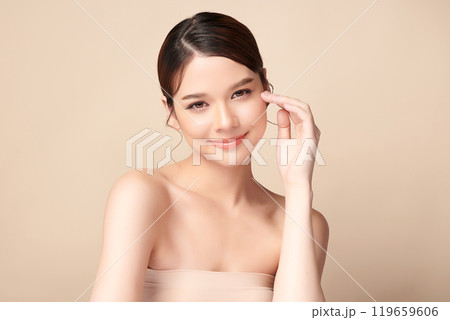 Beautiful young asian woman with clean fresh skin on beige background, Face care, Facial treatment, Cosmetology, beauty and spa, Asian women portrait. 119659606