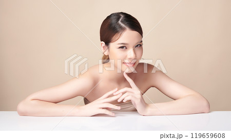 Beautiful young asian woman with clean fresh skin on beige background, Face care, Facial treatment, Cosmetology, beauty and spa, Asian women portrait. Beautiful young asian woman with clean fresh skin on beige background, Face care, Facial treatment, Cosmetology, beauty and spa, Asian women portrait. 119659608