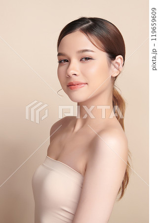 Beautiful young asian woman with clean fresh skin on beige background, Face care, Facial treatment, Cosmetology, beauty and spa, Asian women portrait. 119659609