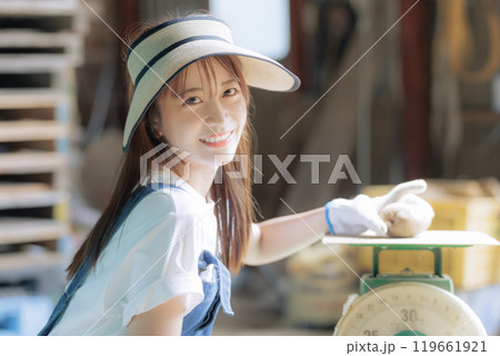 収穫した野菜の出荷準備をしている若い女性 収穫した野菜の出荷準備をしている若い女性 119661921