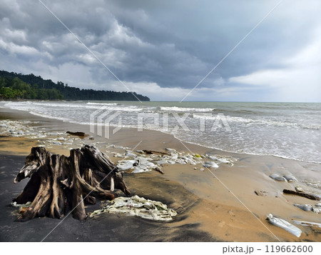 Trash scattered all over the beach close to the ocean Trash scattered all over the beach close to the ocean 119662600