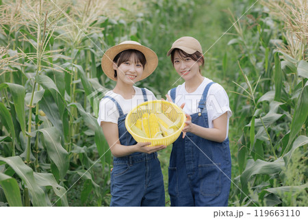 収穫した野菜と一緒に佇む若い女性達 119663110