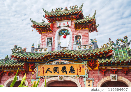 Beautiful ancient red Asian gate to Buddhist pagoda in old town in Hoi An in Vietnam in Asia 119664407