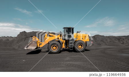 Loading of an loader into railway wagons. Excavator loading coal into wagons. Loading of coal truck using excavator. Shipment coal for transportation by rail Loading of an loader into railway wagons. Excavator loading coal into wagons. Loading of coal truck using excavator. Shipment coal for transportation by rail 119664936
