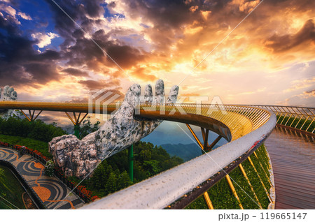 Golden Bridge or Hand of Gods bridge at Sun World Ba Na Hills amusement Park in Da Nang in Vietnam on mountain at sunrise in summer 119665147