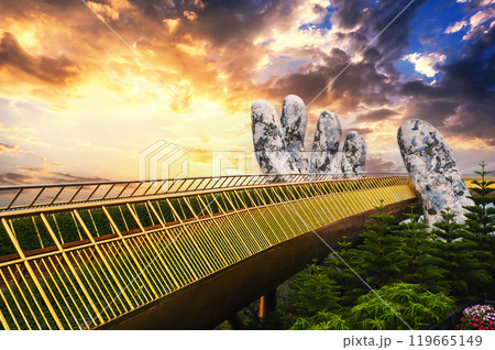 Golden Bridge Hands of God at the Sun World Ba Na Hills park in Da Nang on mountain at sunset in summer in Vietnam 119665149