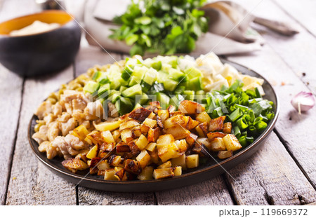 ingredients for salad. chicken, fried potato and vegetables ingredients for salad. chicken, fried potato and vegetables 119669372