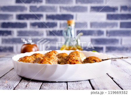 Baked chicken balls, meat balls with white sauce and cheese 119669382
