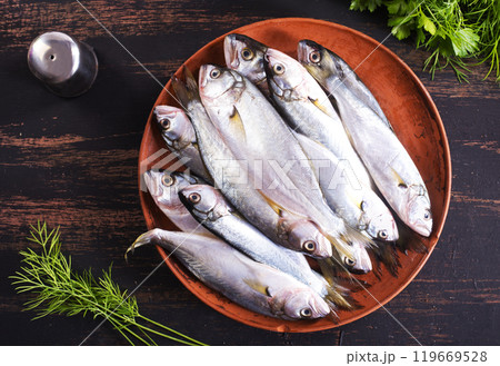Small fish for cooking, fish on plate 119669528