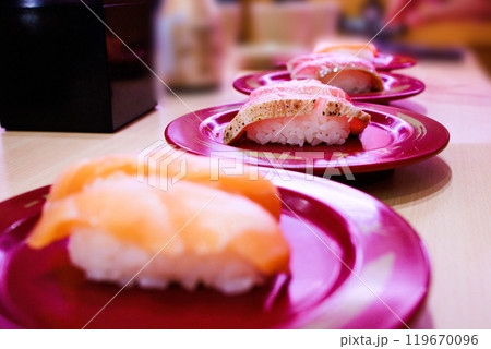 Top view of Japanese fresh salmon sushi with Japanese rice in red plate, focus selective Top view of Japanese fresh salmon sushi with Japanese rice in red plate, focus selective 119670096