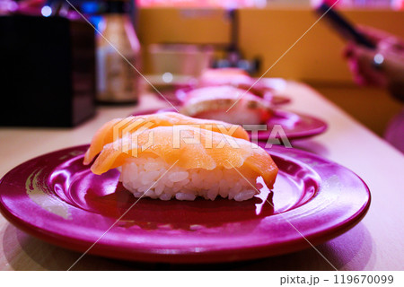 Top view of Japanese fresh salmon sushi with Japanese rice in red plate, focus selective Top view of Japanese fresh salmon sushi with Japanese rice in red plate, focus selective 119670099