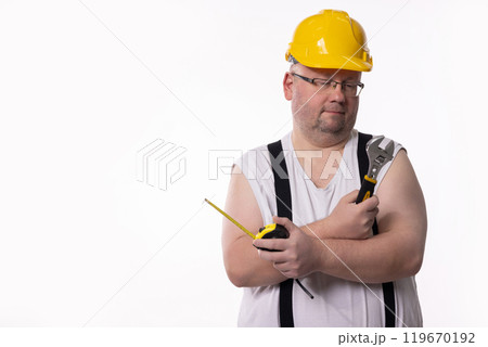 A Construction Worker Dressed in Casual Attire, Equipped with Various Tools Ready for Use 119670192