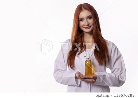 Expert in the laboratory specializing in the use of herbal oils within a laboratory environment Expert in the laboratory specializing in the use of herbal oils within a laboratory environment 119670295