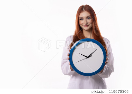 A Smiling Woman Holding a Clock Against a Bright, Clean White Background for Context A Smiling Woman Holding a Clock Against a Bright, Clean White Background for Context 119670503