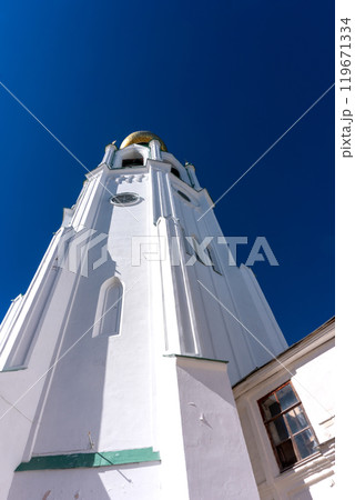 Bell tower of the Vologda Kremlin. A majestic structure with a golden dome against the blue sky. Bell tower of the Vologda Kremlin. A majestic structure with a golden dome against the blue sky. 119671334