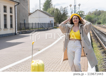 On the threshold of impressions: the image of the traveler conveys the expectation of discoveries and opportunities during a tourist trip. Under the sign of rest: a woman with a suitcase expresses her On the threshold of impressions: the image of the traveler conveys the expectation of discoveries and opportunities during a tourist trip. Under the sign of rest: a woman with a suitcase expresses her 119671443
