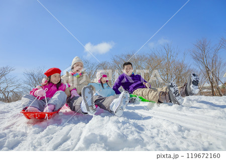 雪の公園でソリ遊びをする4人家族 雪の公園でソリ遊びをする4人家族 119672160