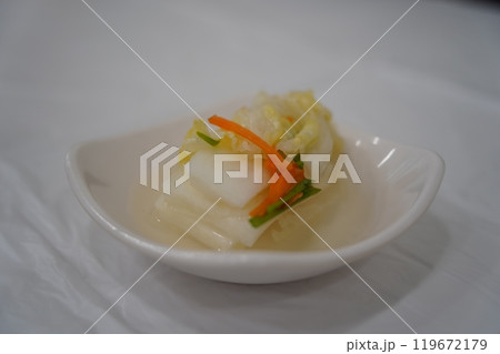 White kimchi is a type of kimchi made without using red pepper powder in Korean cuisine White kimchi is a type of kimchi made without using red pepper powder in Korean cuisine 119672179