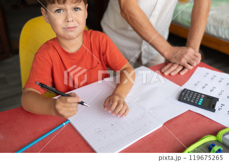 A child with dyscalculia and dyslexia struggles to complete homework. A child with dyscalculia and dyslexia struggles to complete homework. 119675265