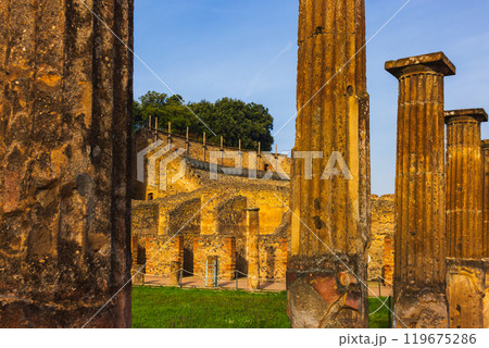 Ancient ruins of Pompei surrounded by lush greenery near Vesuvius volcano 119675286