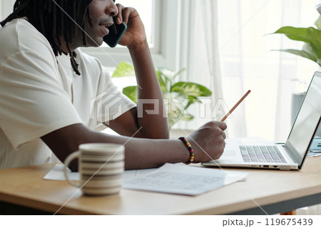 Engaging in a Phone Conversation While Using Laptop Engaging in a Phone Conversation While Using Laptop 119675439