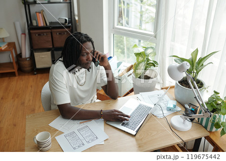 Focused Designer Working at Home Office Desk Focused Designer Working at Home Office Desk 119675442