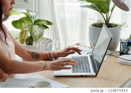 Updating Work Documents on Laptop in Home Office Updating Work Documents on Laptop in Home Office 119675453