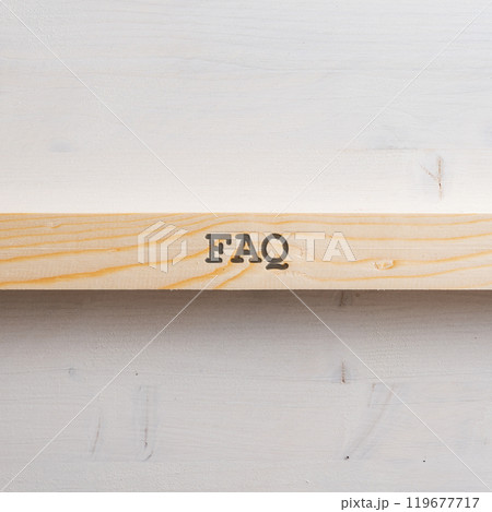 Wooden slat with a FAQ sign on it placed over plain simple wooden background Wooden slat with a FAQ sign on it placed over plain simple wooden background 119677717