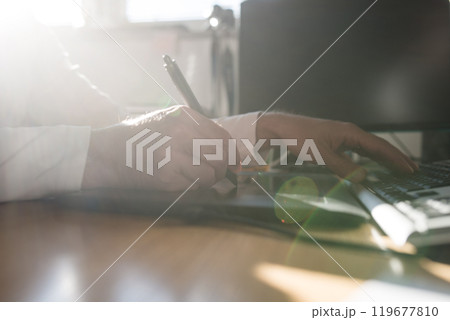 Photographer sketching and drawing with a stylus pen on graphic tablet 119677810