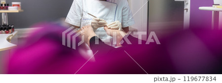Pedicurist making pedicure Pedicurist making pedicure 119677834