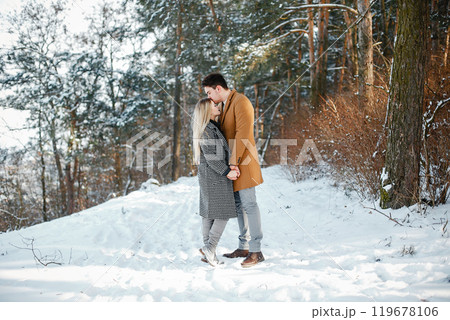 happy young couple walking through the park on a snowy day 119678106
