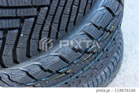 New Winter Tires Stacked On Asphalt Closeup Stock Image. Studless Tires Details 119678186