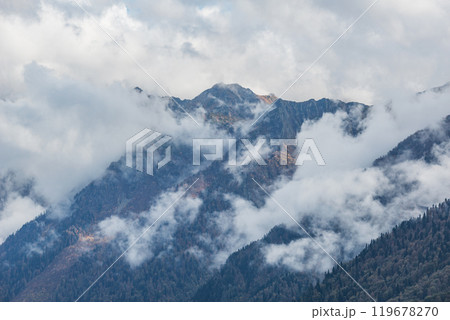 Clouds above the mountain autumn forest at sunset. 119678270
