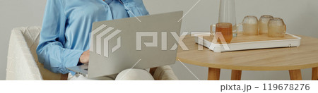 Working Remotely with a Laptop and Beverages Nearby Working Remotely with a Laptop and Beverages Nearby 119678276