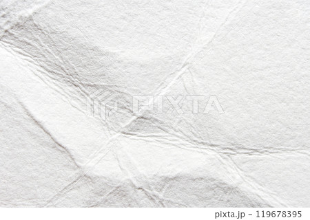 Close-up of crumpled white paper texture with wrinkles and folds for creative 119678395