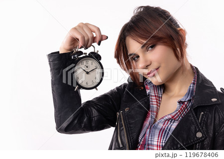 A Young Woman Holding a Vintage Alarm Clock Up Against a Clean, Pristine White Background A Young Woman Holding a Vintage Alarm Clock Up Against a Clean, Pristine White Background 119678406