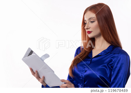 An Elegant Woman Deeply Engrossed in a Book While Dressed in Stylish and Fashionable Attire An Elegant Woman Deeply Engrossed in a Book While Dressed in Stylish and Fashionable Attire 119678489