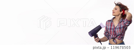 A Stylish and Young Woman Holding a Hair Dryer in a Fun and Playful Pose with Confidence A Stylish and Young Woman Holding a Hair Dryer in a Fun and Playful Pose with Confidence 119678503