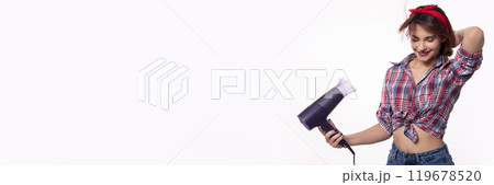 Stylish and confident woman holding a hair dryer while showcasing her bright fashion sense 119678520