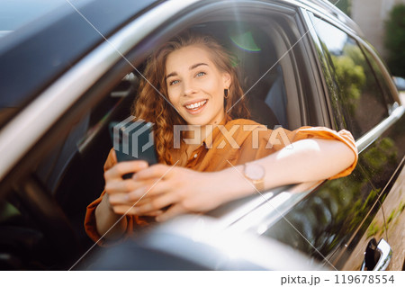The driver of the car uses a smartphone. Leisure, travel, technology, navigation. 119678554