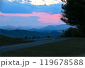 Scenic mountain road at twilight with colorful sunset sky 119678588