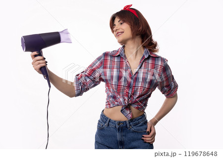 A Stylish Young Woman is Confidently Wielding a Hair Dryer with Flair, Elegance, and Attitude A Stylish Young Woman is Confidently Wielding a Hair Dryer with Flair, Elegance, and Attitude 119678648