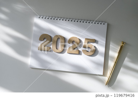 Notepad, pen and gold numbers 2025 on white background Notepad, pen and gold numbers 2025 on white background 119679416