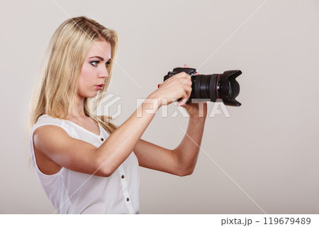 Beautiful woman with camera. 119679489