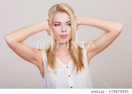 Closeup stressed business woman covers ears with hands 119679493