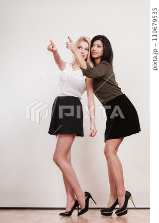 Two fashion women pointing wit finger 119679535