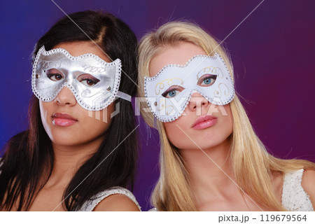 Two women face with carnival venetian masks Two women face with carnival venetian masks 119679564