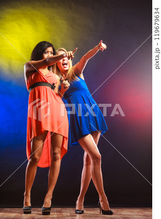 Two funny women in dresses. 119679634