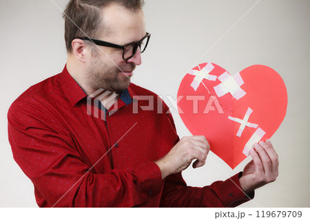 Man holding broken heart 119679709